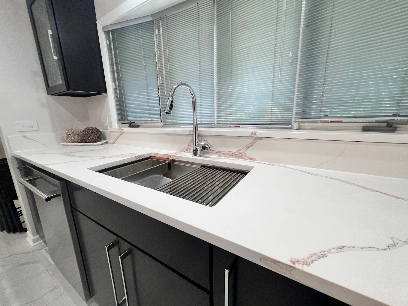 Dark Cabinetry & Marble-Look Kitchen after photo: Workstation sink and countertop detail
