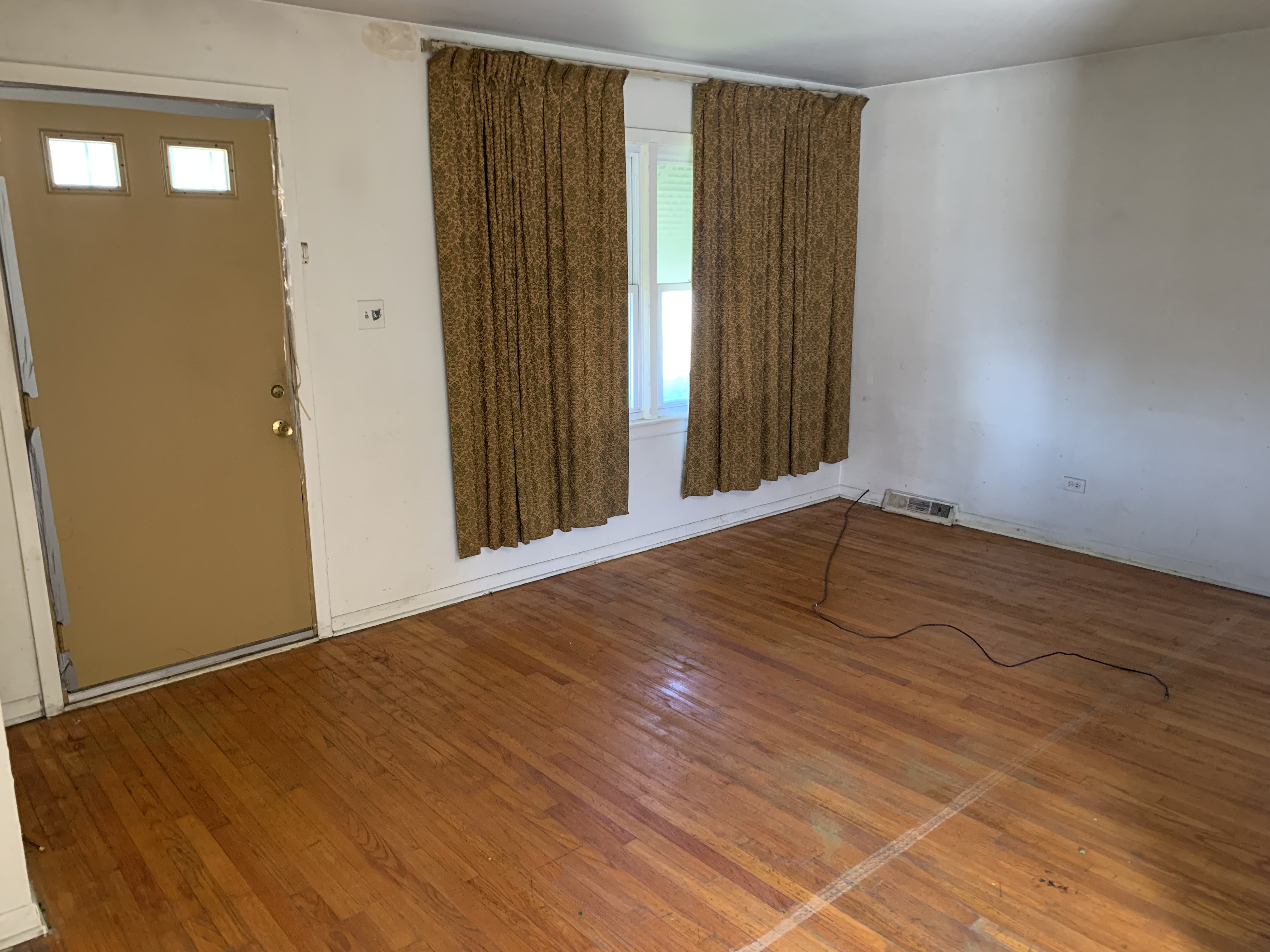 Racine before photo: Living room with original hardwood floors