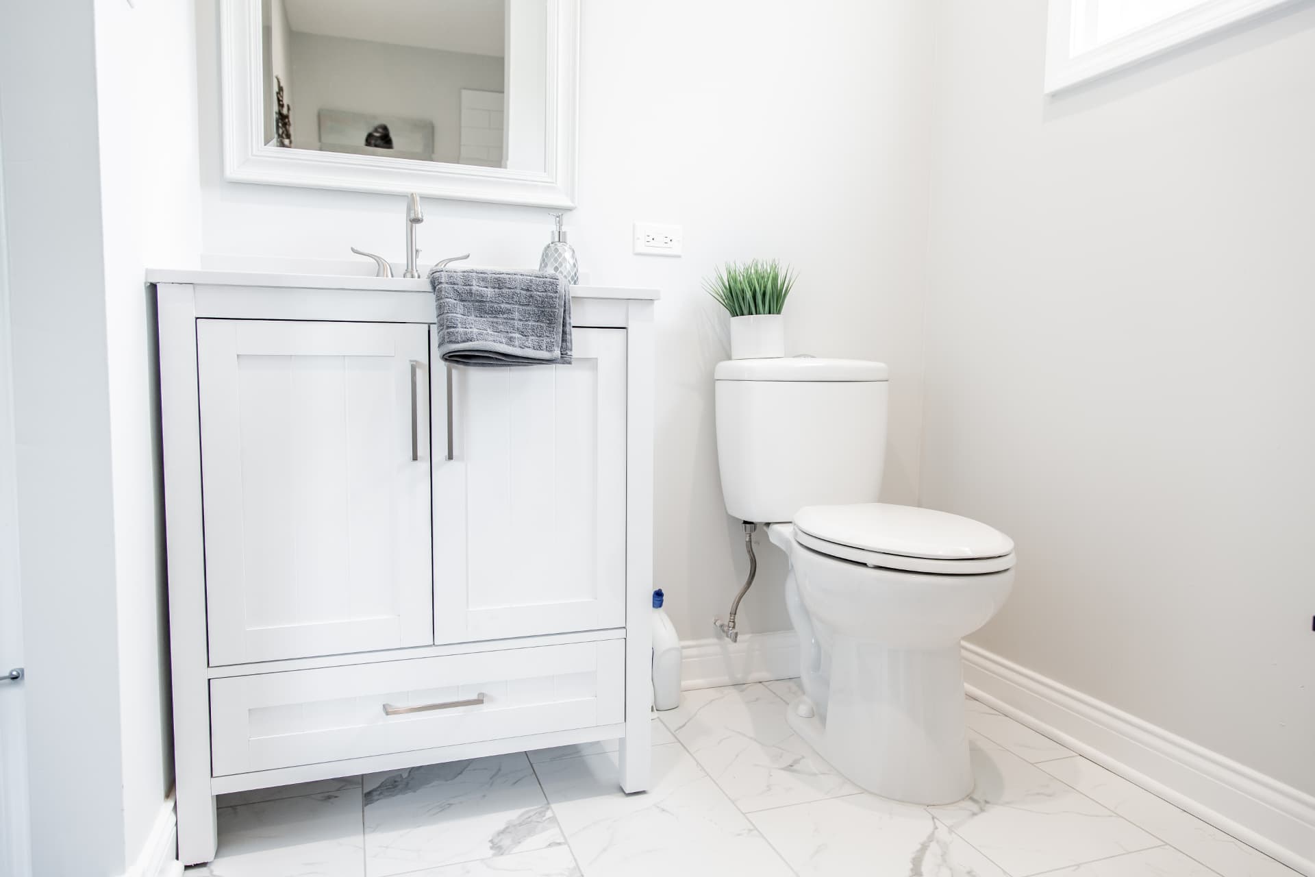 Wood after photo: White vanity, framed mirror, and bathroom floor tile