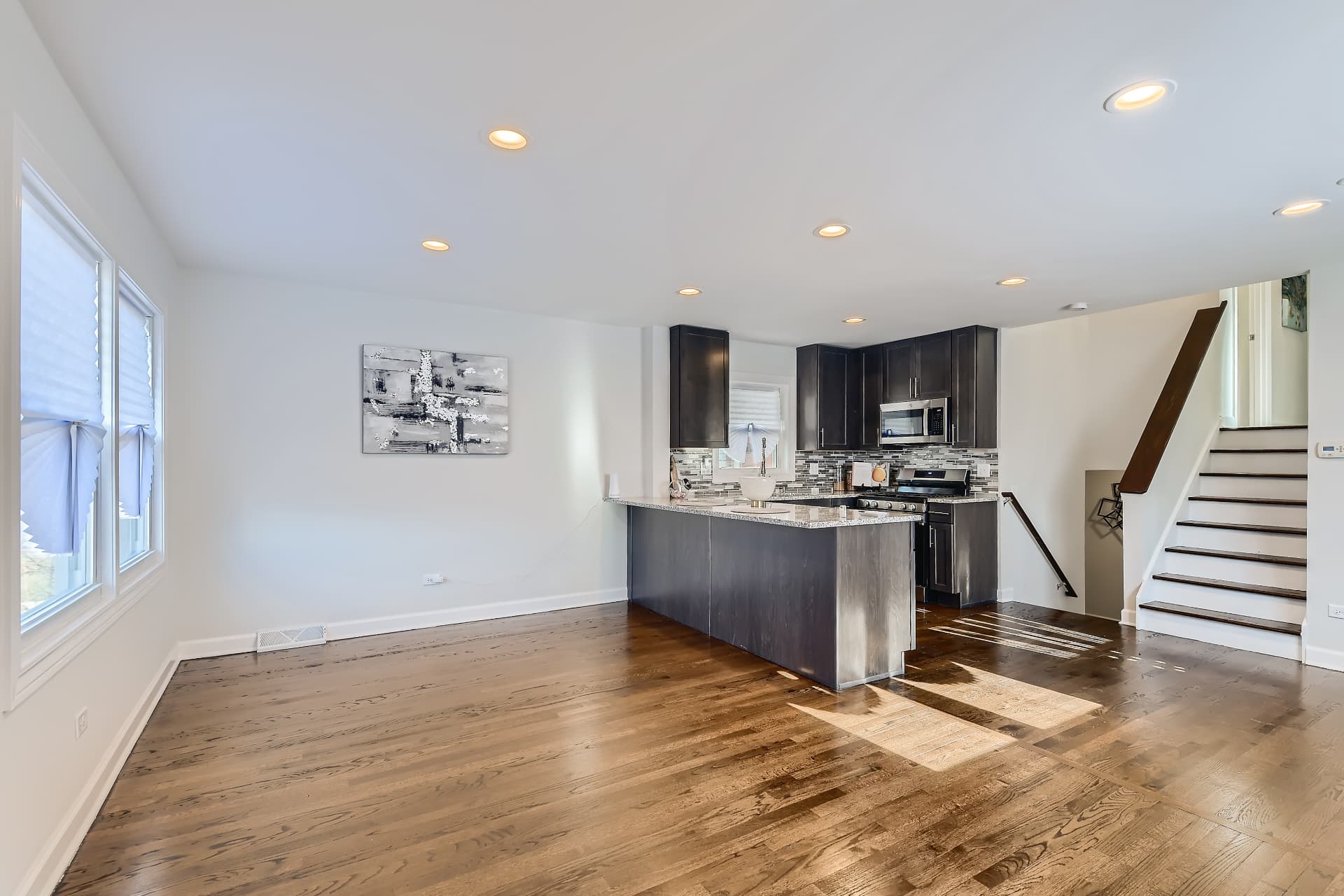 Racine after photo: Open living room and kitchen with hardwood floors