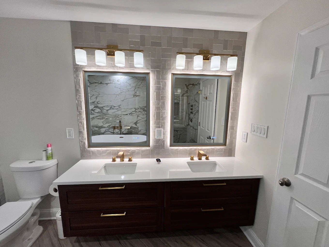 Marble & Gold Primary Bath after photo: Floating double vanity with backlit mirrors
