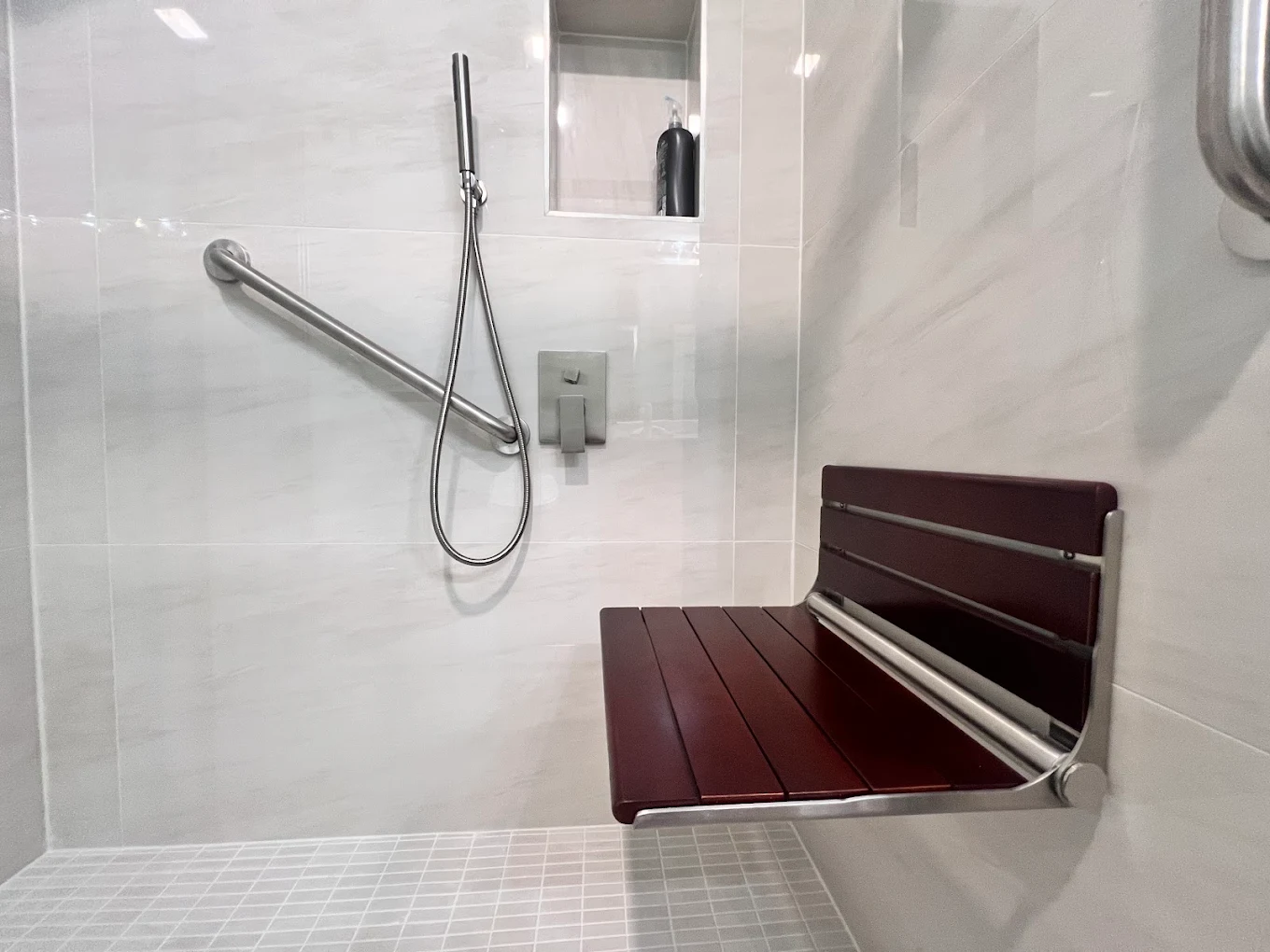 Accessible Walk-In Shower after photo: Fold-down teak shower seat and grab bar