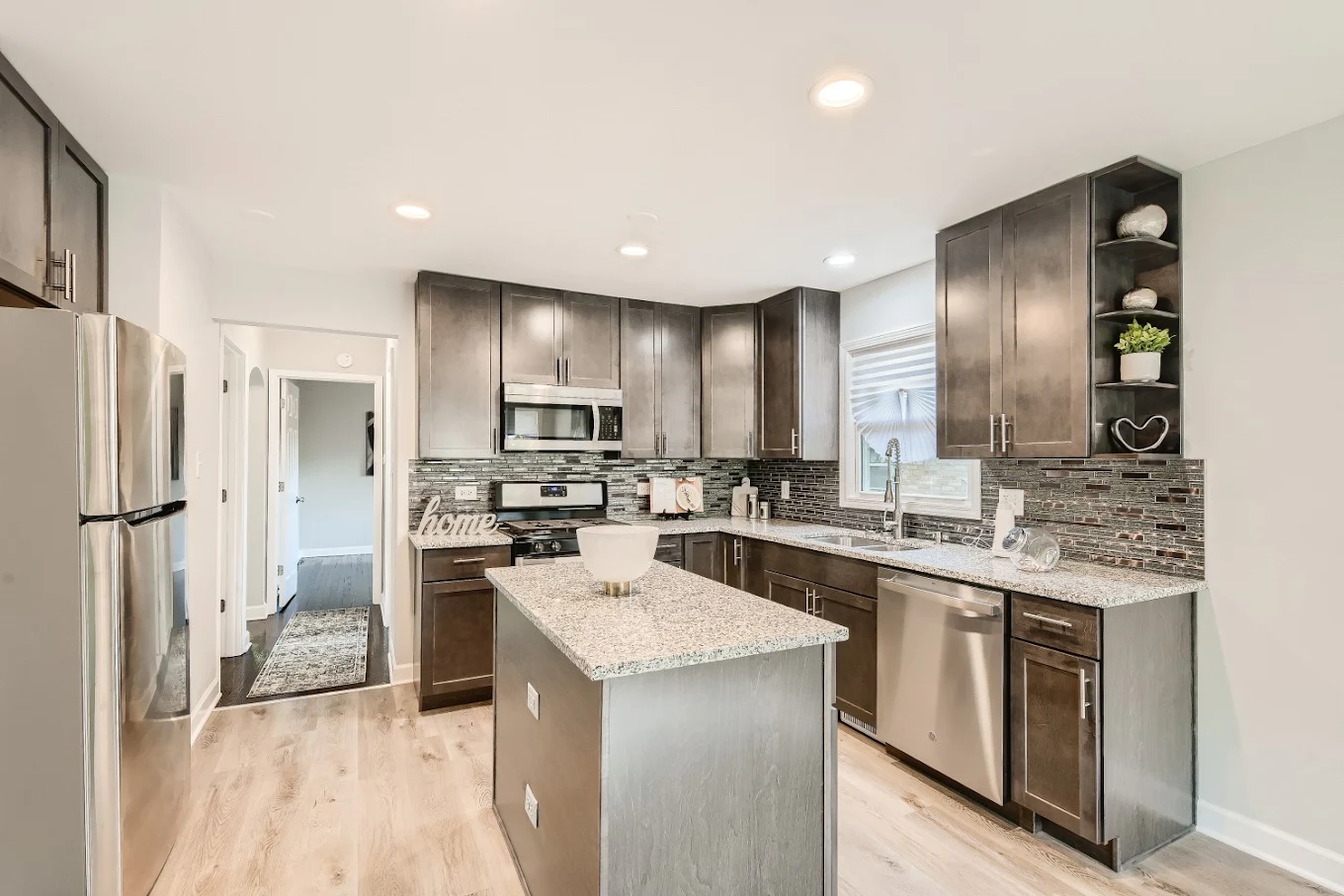 Shaker Kitchen & Mosaic Backsplash after photo: Shaker cabinets, granite island, and glass mosaic backsplash