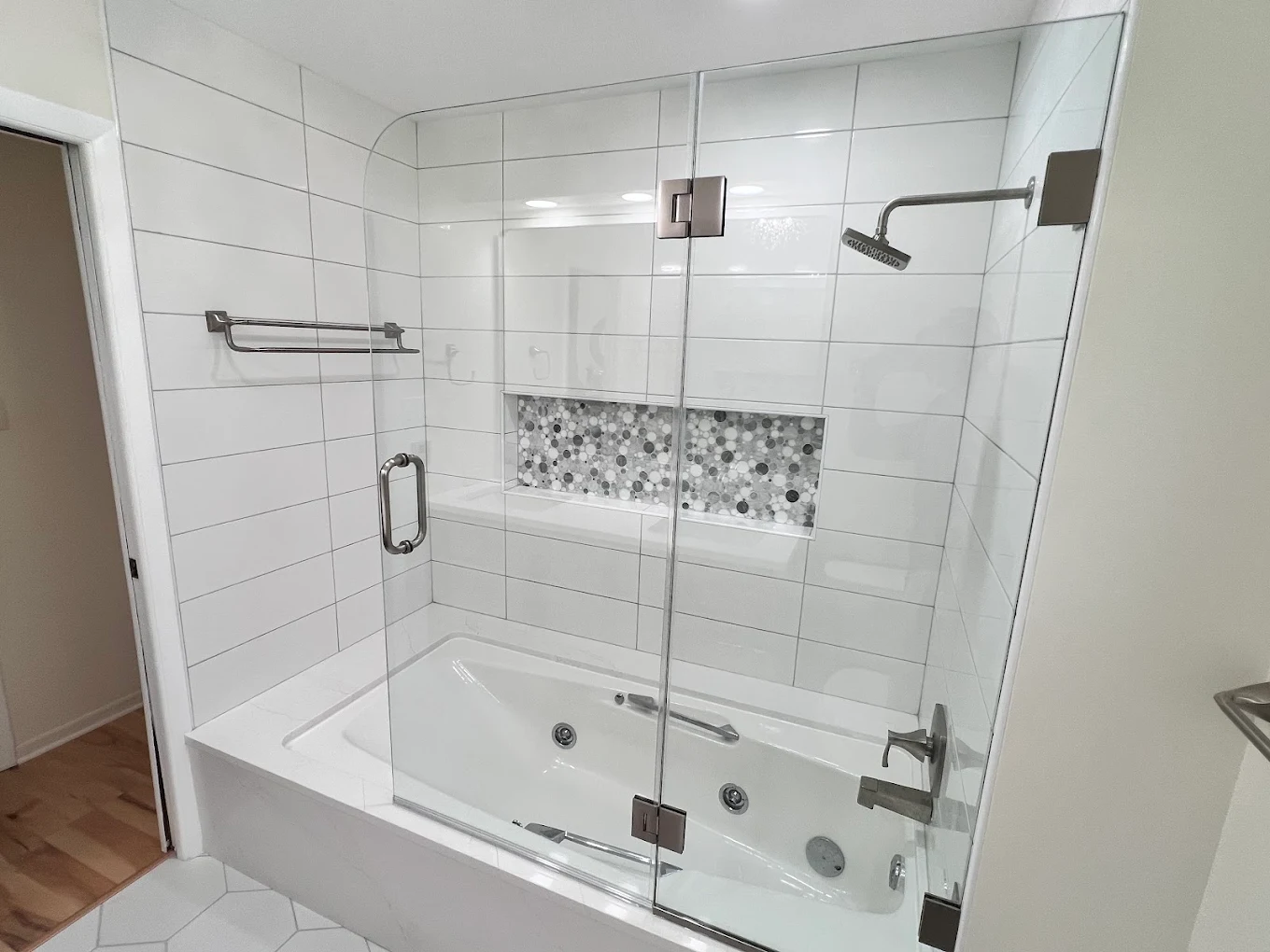 Jetted Tub & Walnut Vanity after photo: Jetted tub-shower with frameless glass and pebble mosaic niche