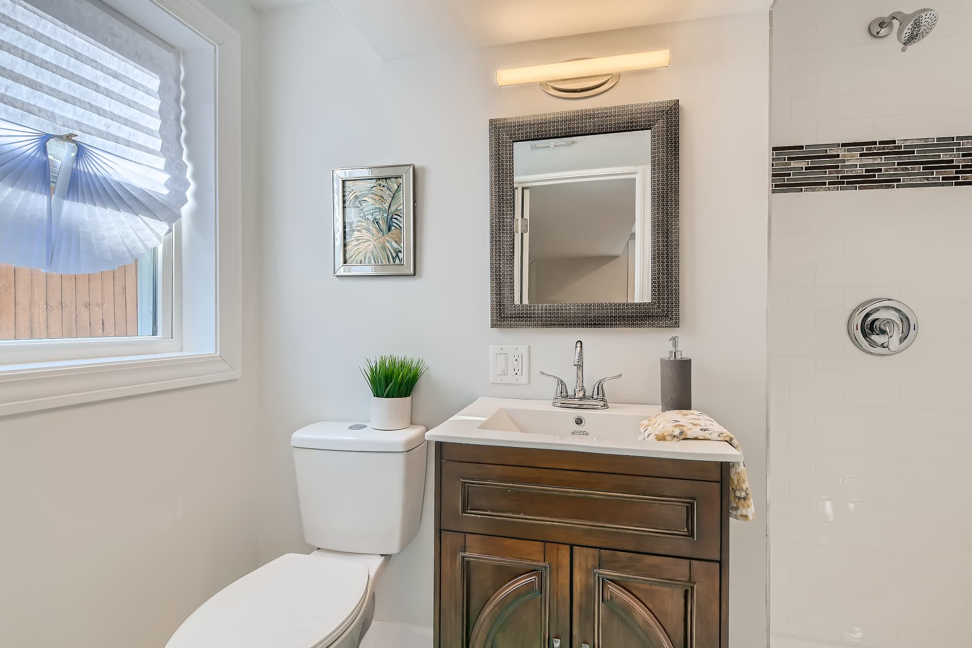 Racine after photo: Lower-level primary bath with tiled shower