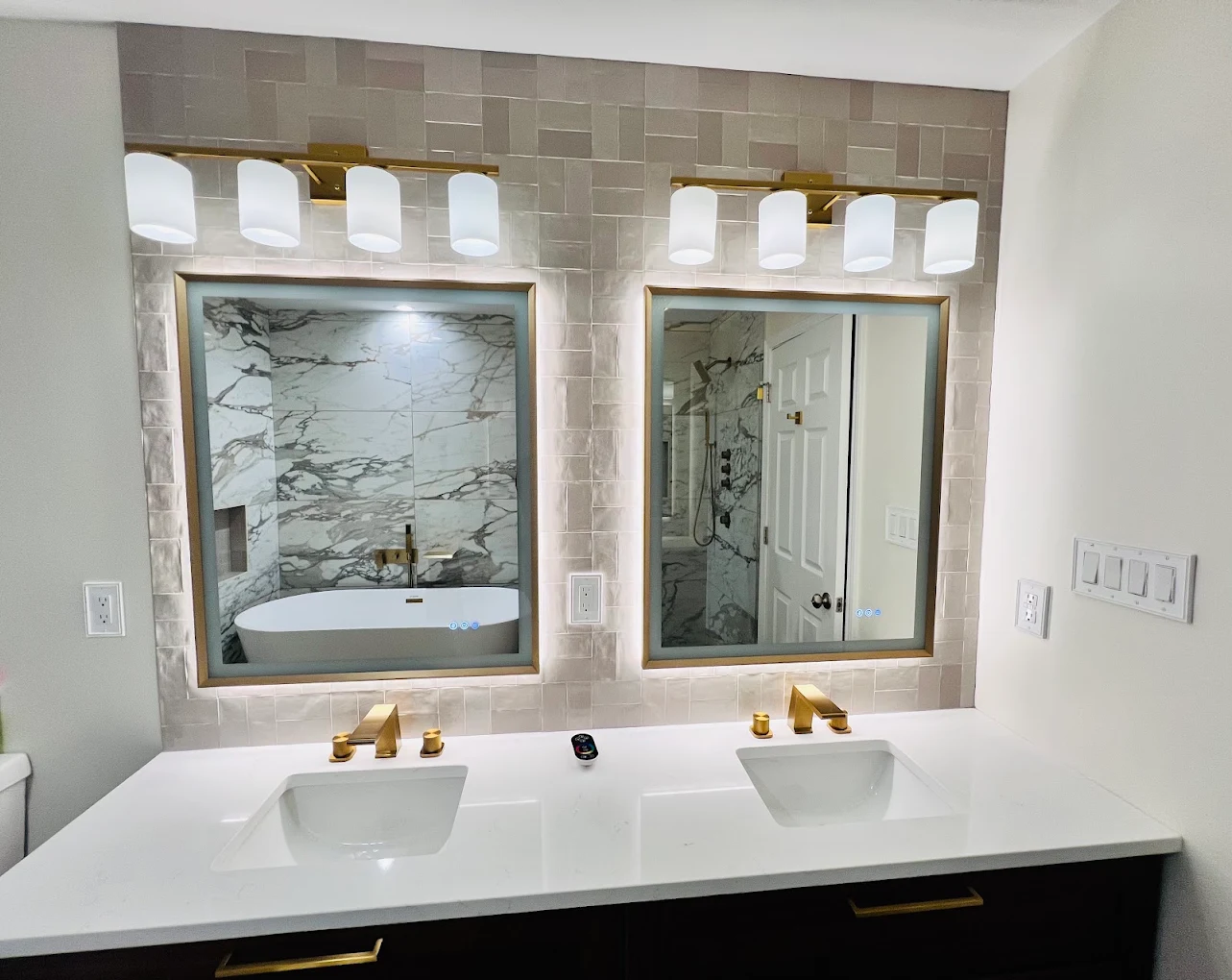 Marble & Gold Primary Bath after photo: Double vanity with gold faucets and handmade-look tile