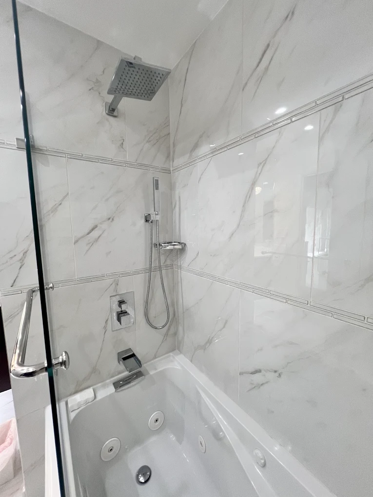 Polished Chrome Jetted Tub after photo: Chrome rain head, hand shower, and accent trim bands