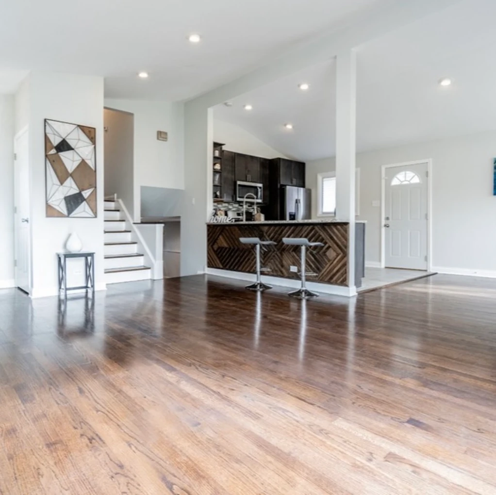 Open Concept Kitchen & Herringbone Island after photo: Open living space with view to the kitchen and staircase