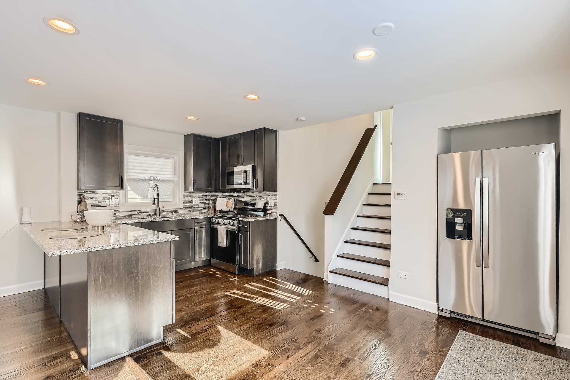 Racine after photo: Kitchen with granite counters and dark cabinetry