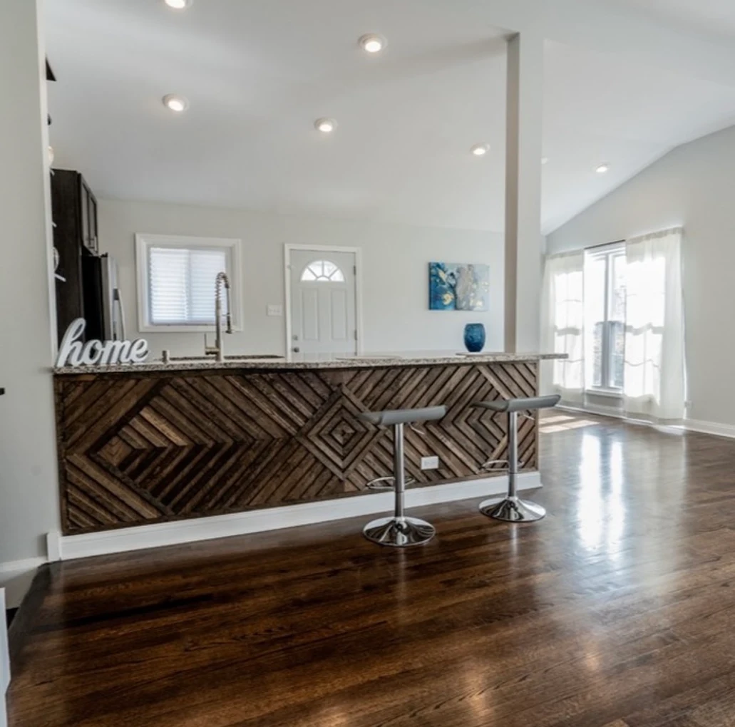 Open Concept Kitchen & Herringbone Island after photo: Granite-topped island with custom herringbone wood front